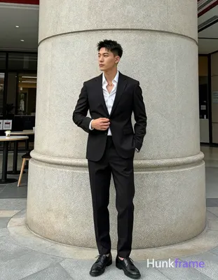 Asian man with short textured black hair styled upward and back, clean-shaven face, neutral composed