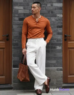 Asian man with short buzz cut and minor chin stubble stands in relaxed contrapposto, weight on right