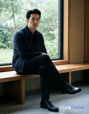 Asian man with fair skin and black short hair styled back with volume at crown, 