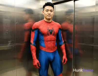 Asian man with light-medium skin and black short spiky hair, clean-shaven face with a neutral slight