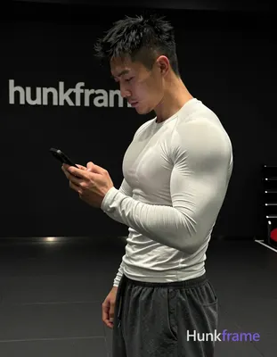 Asian man with short spiky black hair and faded undercut, clean-shaven chin with light upper lip stu