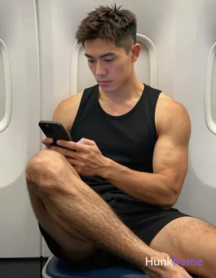 Asian man with light to medium tan skin and short dark brown hair featuring a textured top with fade