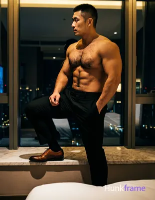 Adult man with short black buzz cut, clean-shaven face, neutral profile gaze lef