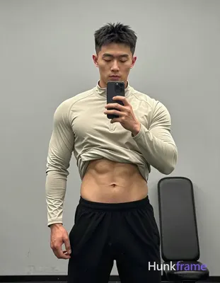 Asian man with short black textured hair and clean-shaven face, eyes closed in neutral expression st