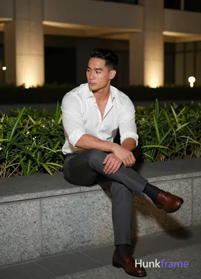 Asian man with short black straight side-parted hair and clean-shaven face, ligh