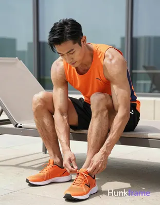 Asian man with medium-tan skin and short black straight side-parted hair, clean-