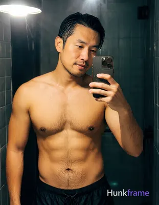 Asian man with light medium tan skin wet sheen, black short slicked back hair receding at temples, c