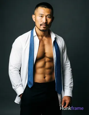 Asian man with medium-tan skin and short black buzz cut, goatee with mustache an