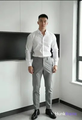 Asian man with short black hair and clean-shaven face, neutral direct gaze standing casually in a mo