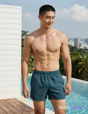Asian man with short black buzz cut and clean-shaven face, light tan skin smiling gently while looki