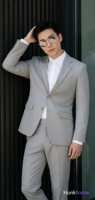 Asian man in a light gray suit jacket, notched lapel, single-button closure with