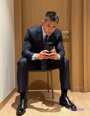 Asian man with light to medium tan skin and short textured dark hair, clean-shaven face wearing a fo