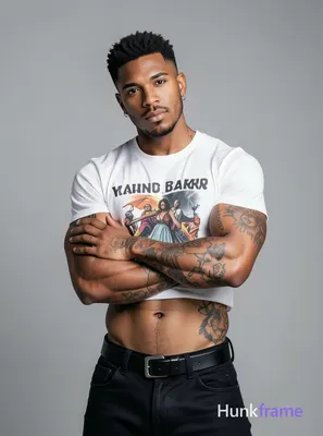 A handsome masculine man standing confidently with his arms crossed over his che