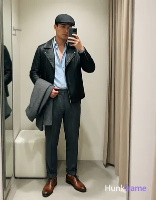 Asian man in XHS lifestyle photography, standing upright facing a full-length mirror holding smartph