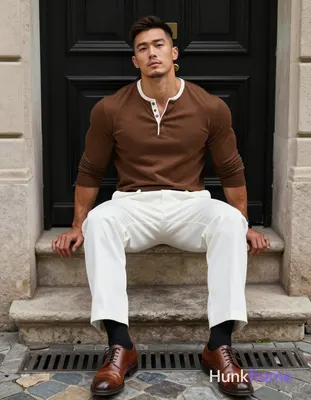 Asian man with light-medium skin and short dark brown undercut hair sits centere