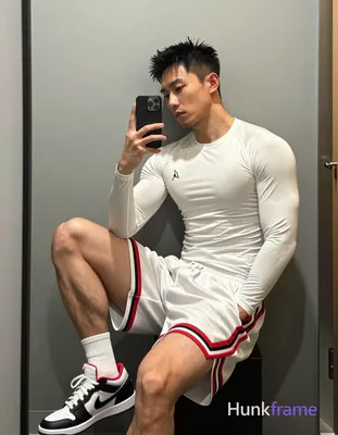 Asian man with light-medium skin and short black textured spiky hair, clean-shaven face in mirror se