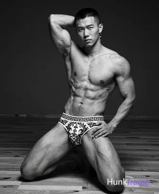 Asian man with medium-dark skin and a short textured black buzz cut, clean-shaven face; Highly muscu