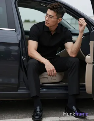 Asian man with short textured dark brown crop hair and side parting, wearing thin metal rimmed glass