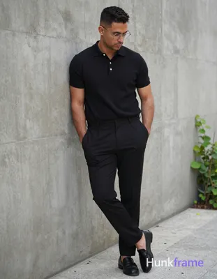 A handsome adult man with medium-dark skin and short dark hair featuring a textu