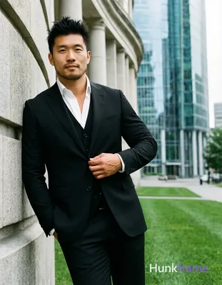 Asian man with light to medium tan skin and short textured black hair styled upward, clean-shaven fa