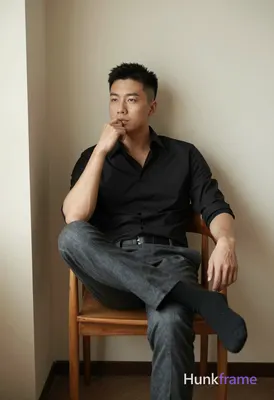 Striking vertical phone wallpaper featuring an adult man with short black hair and clean-shaven face