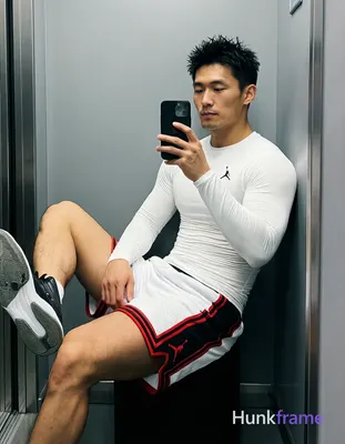 Asian man with light-medium skin and short black textured spiky hair, clean-shaven face in mirror se