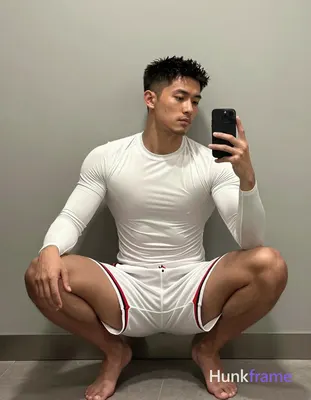 Asian man with short textured dark black hair and clean-shaven face, wearing white long-sleeve compr