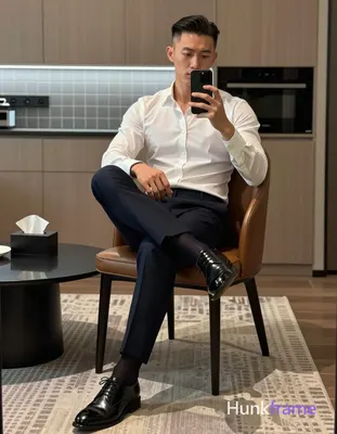 Adult man, slim build with defined athletic posture, short dark brown/black side-parted slick-back h
