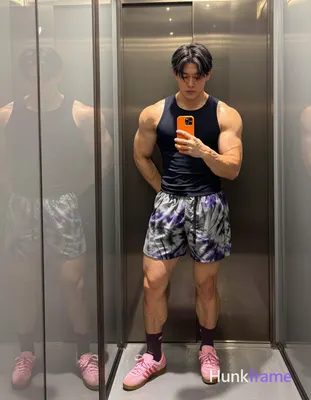 Asian man with medium-dark skin and short black straight hair stands in a full-b